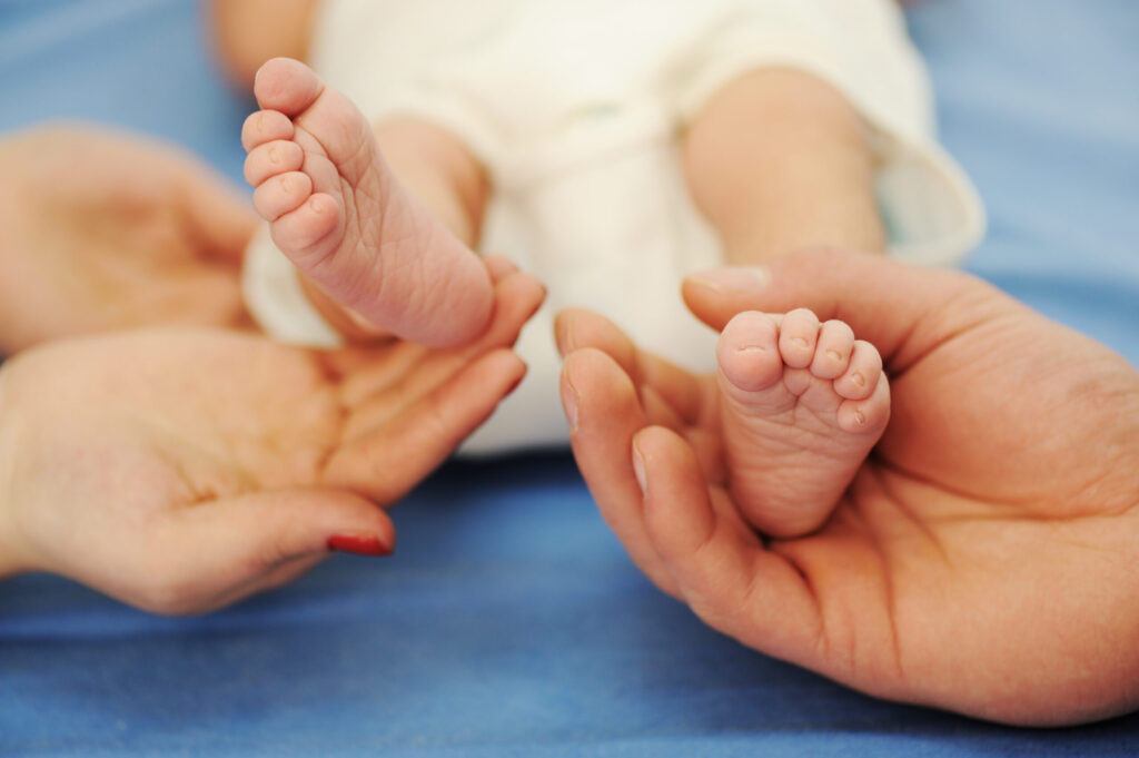 Parents holding baby feet